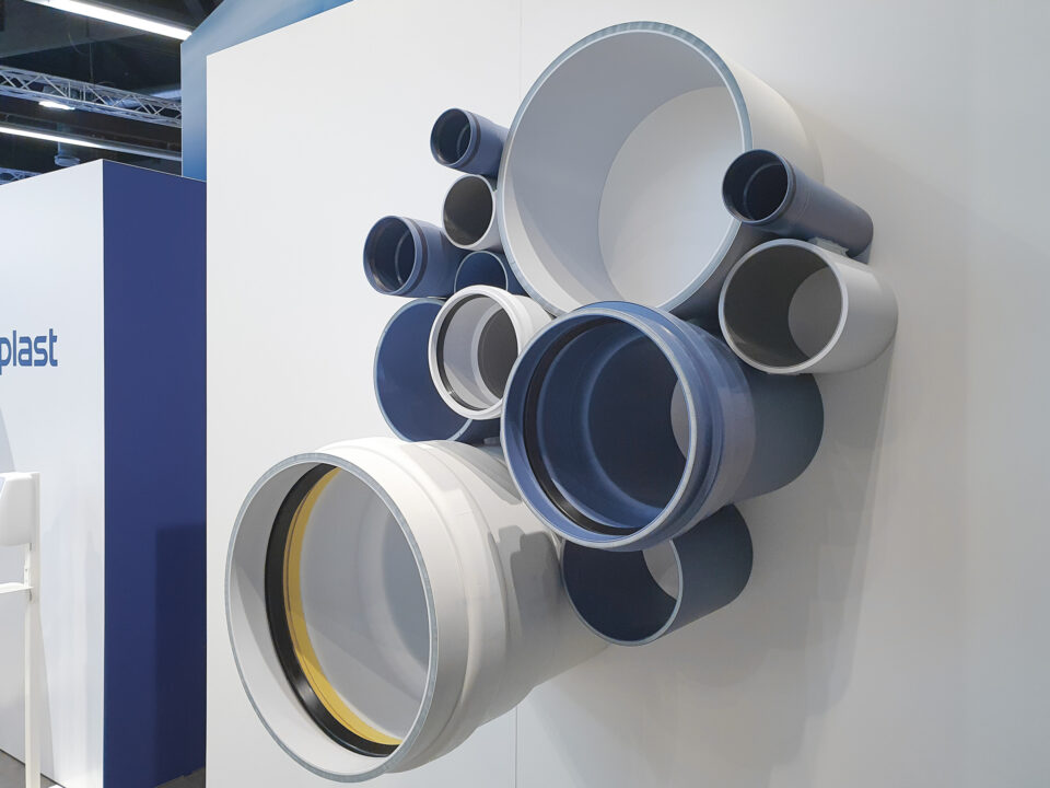 Detailansicht der dekorativ angeordneten POLOPLAST-Rohre in verschiedenen Durchmessern, als ästhetisch-technisches Element im Messestand integriert.